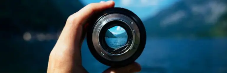 photographer holding a camera lens focusing during the travel 768x247